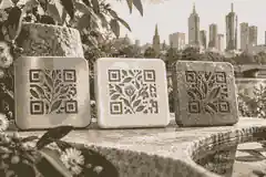 Outdoor QR plaque material samples in restrained memorial finishes