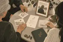 Family arranging memory cards and poem beside a framed photograph